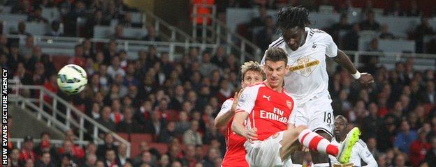 Bafetimbi Gomis heads in the winner against Arsenal at the Emirates Stadium
