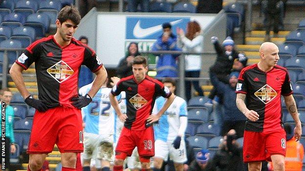 Swansea City players look dejected after the 3-1 FA Cup defeat against Championship side Blackburn Rovers