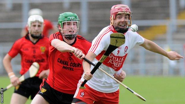Derry's Kevin Hinphey battles with Down's Ben Toner in the Ulster semi-final in 2012