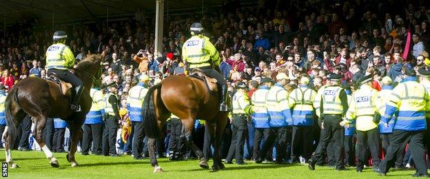 Mounted police and stewards gather in front of the Motherwell fans