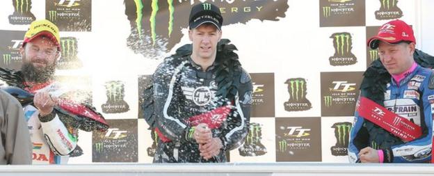 Ian Hutchinson celebrates an emotional TT victory with runners-up Bruce Anstey and Gary Johnson