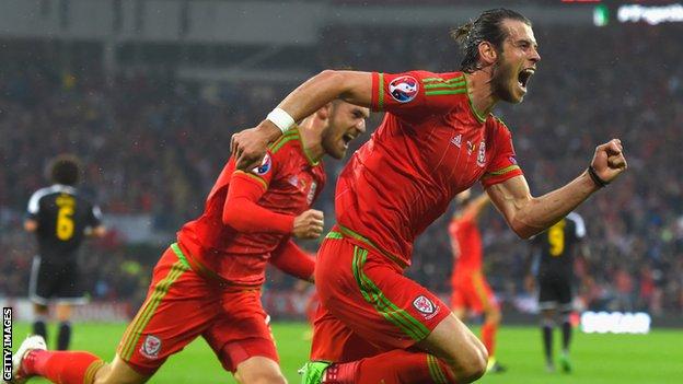 Goal-scorer Gareth Bale and Aaron Ramsey celebrate after taking the lead against Belgium