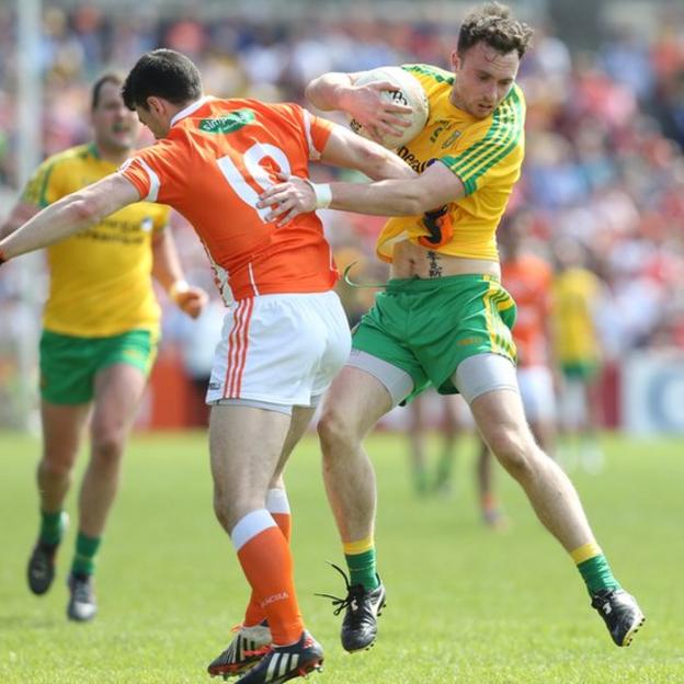 Martin McElhinney of Donegal attempts to get past Caolan Rafferty of Armagh during the Ulster Championship clash