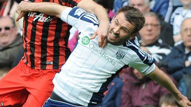 Gareth McAuley challenges for an aerial ball with Clint Hill