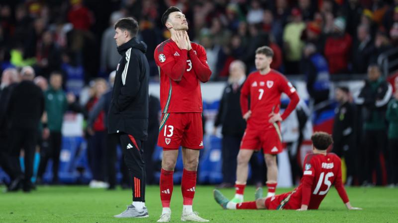 Wales players look dejected after defeat by Poland on penalties