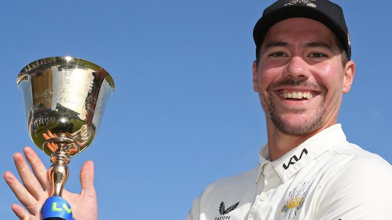 Rory Burns lifts the County Championship trophy