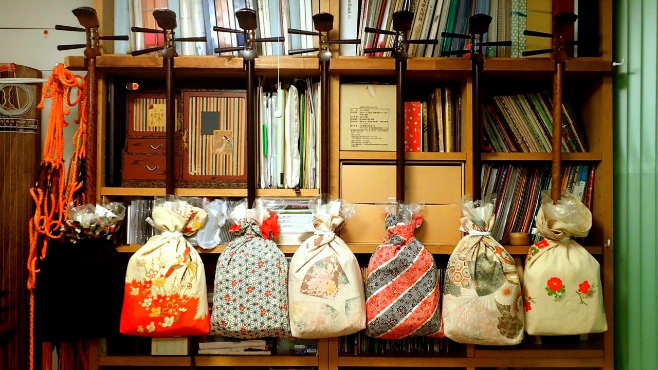 Shamisens hang on the walls of Nishimura's eclectic apartment (Credit: Credit: Celia Knox)