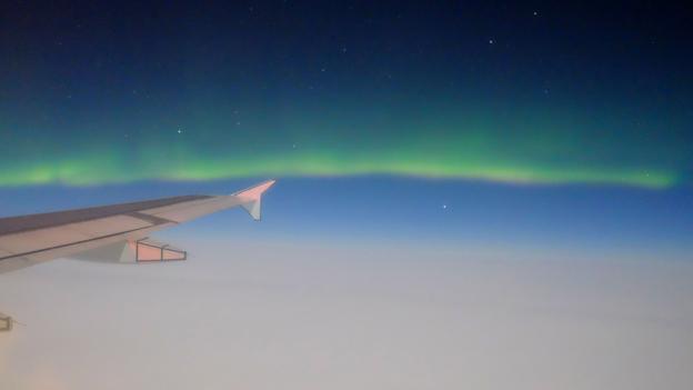 The northern lights fall on the wing tip (Credit: Credit: Germán Poo-Caamaño/Flickr/CC-BY-2.0)