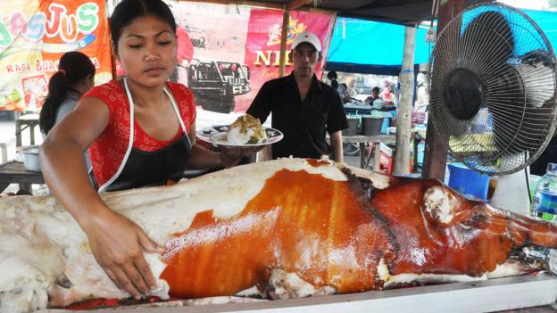 The roasted pig’s golden brown skin chips off like paint (Credit: Credit: age fotostock/Alamy)