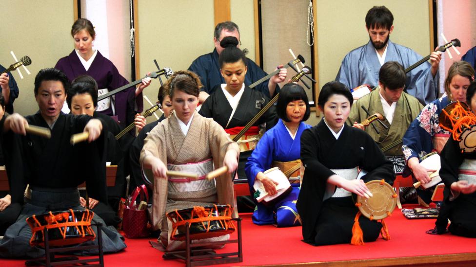 Clad in blue, Nishimura falls to the back and lets her students take centre stage (Credit: Credit: Learning Shamisen)