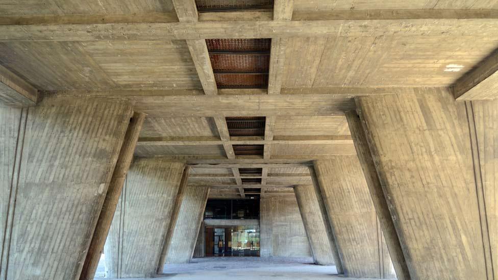 The building is perched on vast, tapered concrete legs known as 'piloti' which increase the building's imposing stature, creating additional space underneath. (Corbis) The building is perched on vast, tapered concrete legs known as 'piloti' which increase the building's imposing stature, creating additional space underneath. (Corbis)
