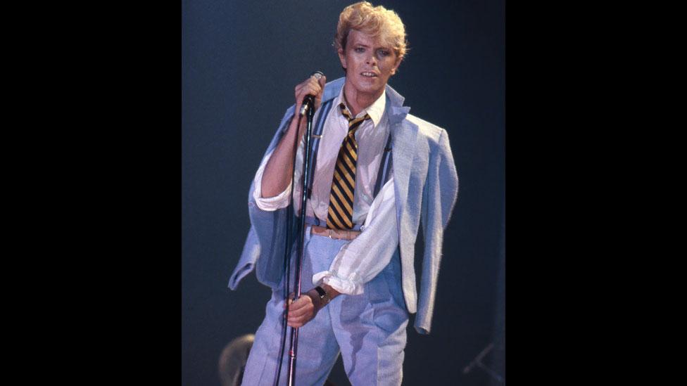 The singer appears suited and booted at the 1983 Serious Moonlight Tour warm-up gig in Brussels, Belgium, which followed his Let’s Dance album from the same year. (Rex Features) The singer appears suited and booted at the 1983 Serious Moonlight Tour warm-up gig in Brussels, Belgium, which followed his Let’s Dance album from the same year. (Rex Features)