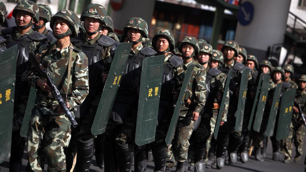 State security policing Urumqi in Xinjiang province during the 2009 riots. (Corbis) State security policing Urumqi in Xinjiang province during the 2009 riots. (Corbis)