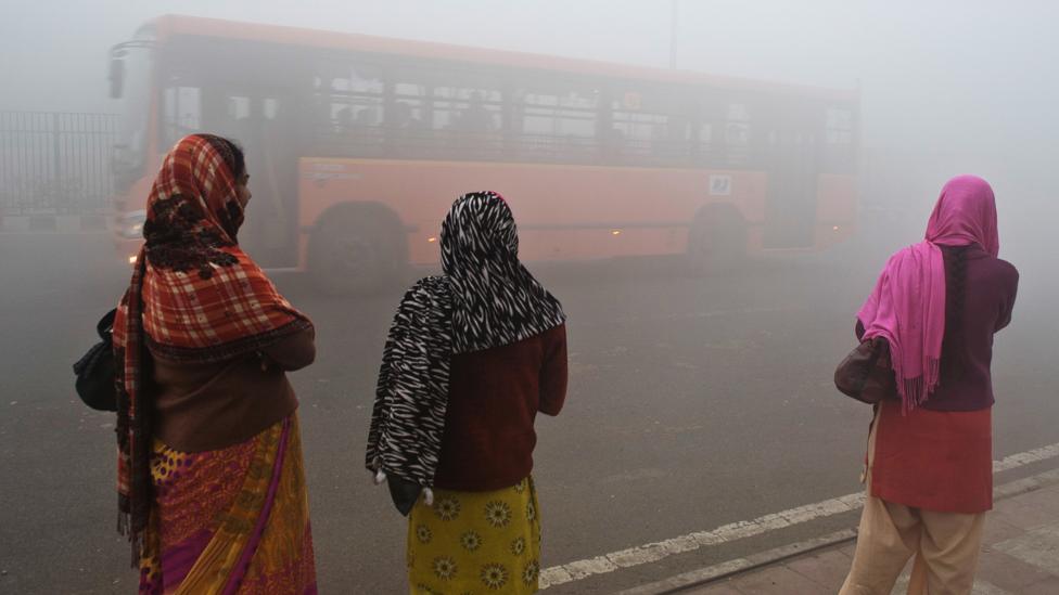 Women wait for a bus in Dehi, under polluted skies. (Prakash Singh/AFP/Getty Images) Women wait for a bus in Dehi, under polluted skies. (Prakash Singh/AFP/Getty Images)