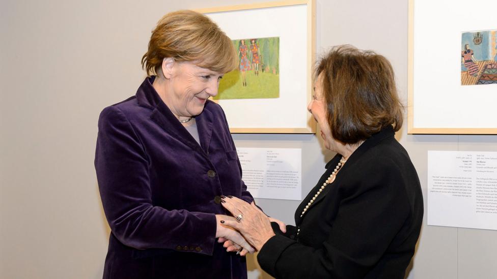 Angela Merkel was pictured with Nelly Toll in front of Girls in the Field, which Toll had painted aged 8 in a Jewish ghetto in Poland (Credit: Rex Features) Angela Merkel was pictured with Nelly Toll in front of Girls in the Field, which Toll had painted aged 8 in a Jewish ghetto in Poland (Credit: Rex Features)