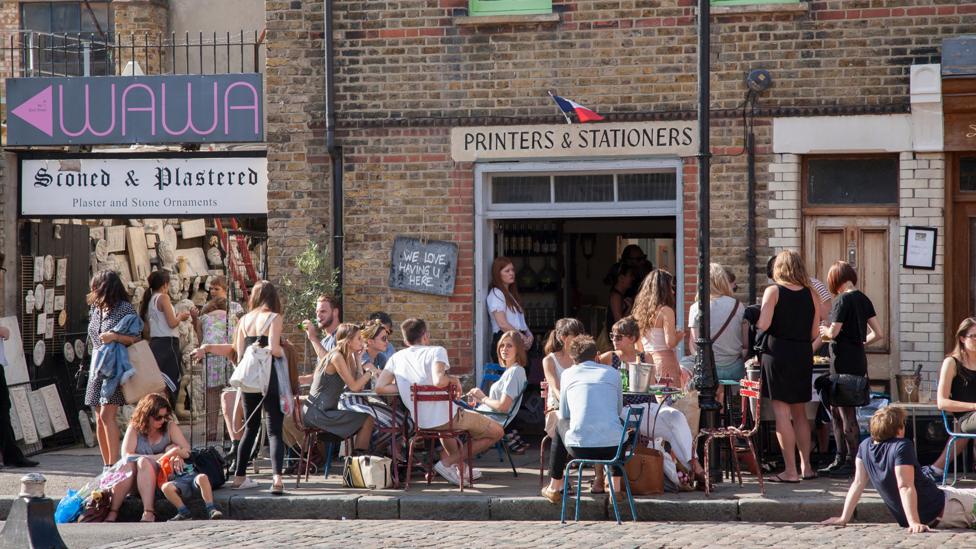 People gather at a wine bar in Shoreditch, east London (Credit: Kevin George/Alamy) People gather at a wine bar in Shoreditch, east London (Credit: Kevin George/Alamy)