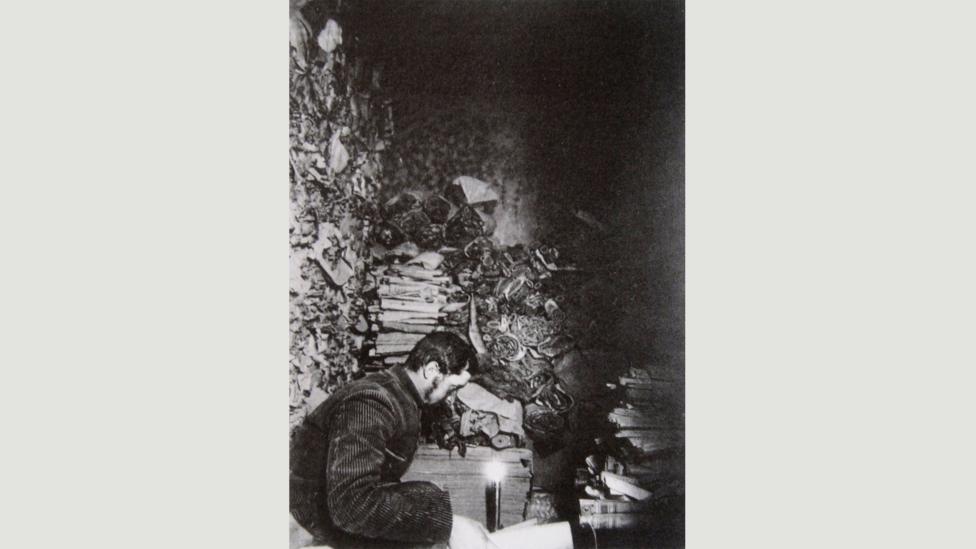 French sinologist Paul Pelliot in the Library Cave at Dunhuang in 1908 reading the manuscripts (Credit: The Musée Guimet) French sinologist Paul Pelliot in the Library Cave at Dunhuang in 1908 reading the manuscripts (Credit: The Musée Guimet)