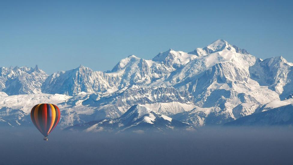 A hot air balllon and the European Alps (Credit: Photographer Chris Archinet/ GettyImages) A hot air balllon and the European Alps (Credit: Photographer Chris Archinet/ GettyImages)
