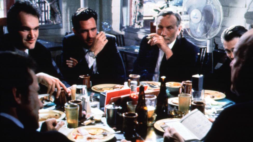 Tarantino opens the film with the characters around a diner table – juvenile, volatile and afraid of women (Credit: Moviestore Collection Ltd / Alamy Stock Photo) Tarantino opens the film with the characters around a diner table – juvenile, volatile and afraid of women (Credit: Moviestore Collection Ltd / Alamy Stock Photo)