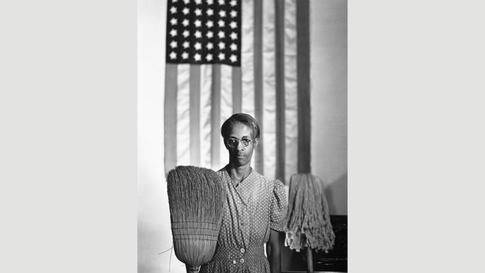 Gordon Parks’ 1942 photograph of Ella Watson riffs on American Gothic for a serious rather than comic effect (Credit: Getty Images) Gordon Parks’ 1942 photograph of Ella Watson riffs on American Gothic for a serious rather than comic effect (Credit: Getty Images)