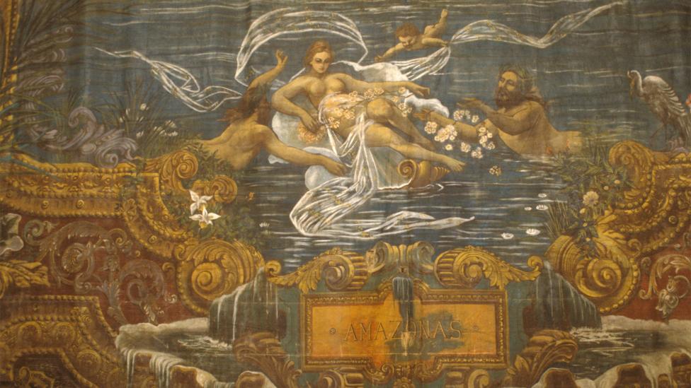 The stage curtain, illustrated by Brazilian painter Crispim do Amaral, depicts the goddess Iara amid the ‘meeting of the waters’ (Credit: Alamy) The stage curtain, illustrated by Brazilian painter Crispim do Amaral, depicts the goddess Iara amid the ‘meeting of the waters’ (Credit: Alamy)