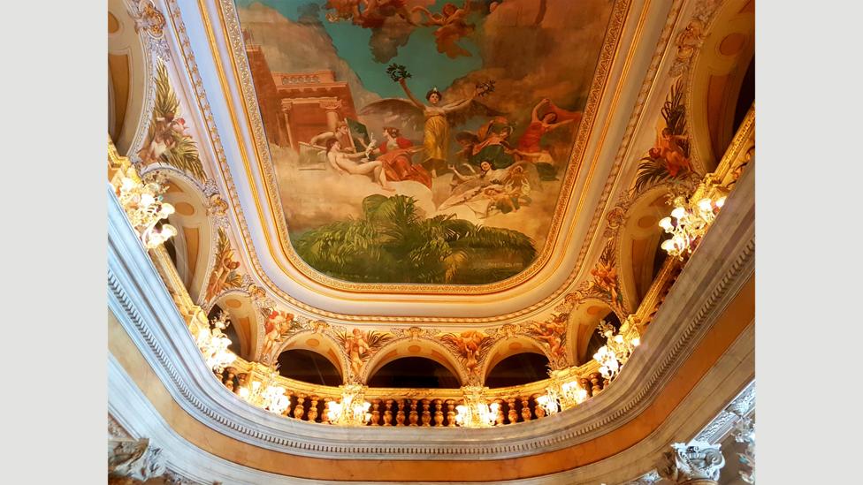 The ballroom’s ceiling features The Glorification of the Arts, a painting in which gods and goddesses bestow their gifts from above (Credit: Benjamin Ramm/Emma Bridget Byrne) The ballroom’s ceiling features The Glorification of the Arts, a painting in which gods and goddesses bestow their gifts from above (Credit: Benjamin Ramm/Emma Bridget Byrne)