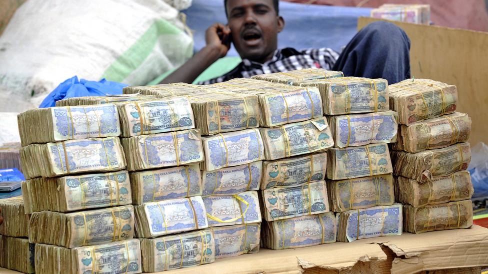One US dollar equals 9,000 Somliland shillings - the currency is so devalued, shoppers wander markets with wads of the paper money thrown in their bags (Credit: AFP/Simon Maina) One US dollar equals 9,000 Somliland shillings - the currency is so devalued, shoppers wander markets with wads of the paper money thrown in their bags (Credit: AFP/Simon Maina)
