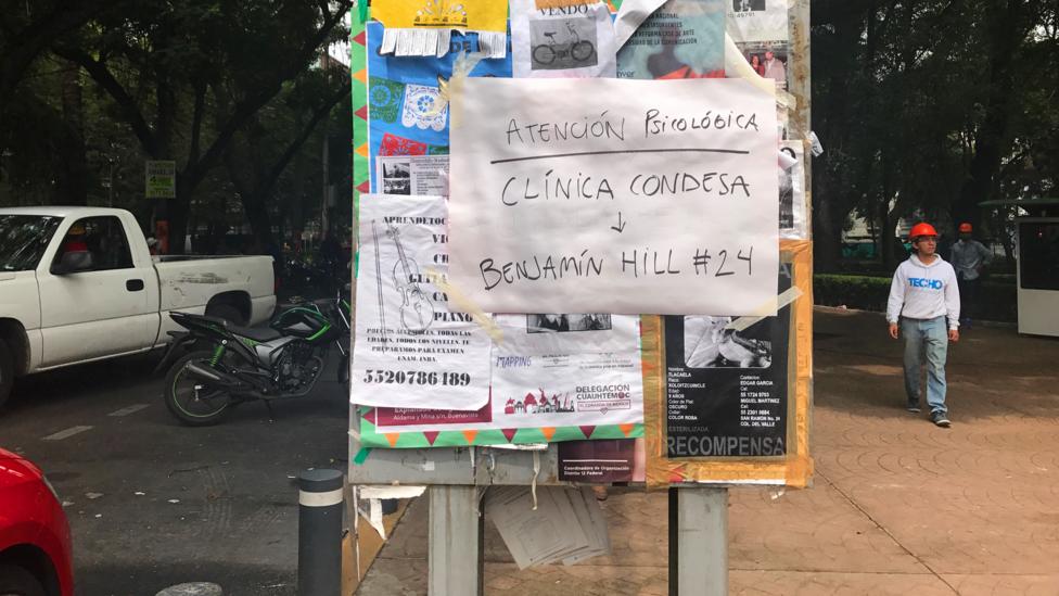 A sign in Mexico City advertises psychological help to residents. Some psychologists took to writing their names and numbers (Credit: Julissa Trevino) A sign in Mexico City advertises psychological help to residents. Some psychologists took to writing their names and numbers (Credit: Julissa Trevino)