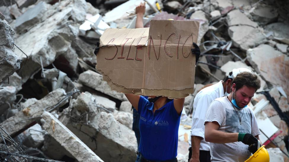 Rescue workers calling for silence (Credit: Getty Images) Rescue workers calling for silence (Credit: Getty Images)