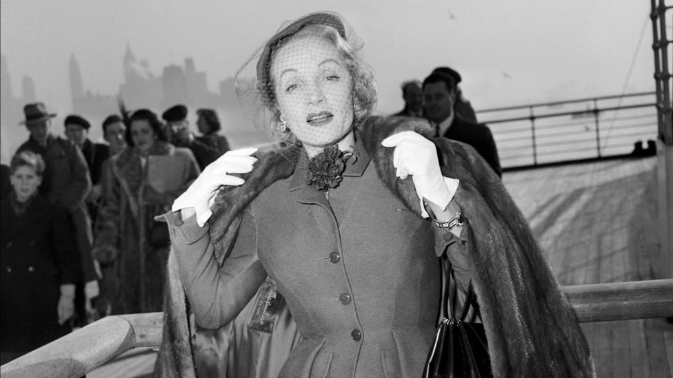 Marlene Dietrich cuts a glamorous figure as she poses in a day suit by Christian Dior on board the Queen Elizabeth in 1950 (Credit: Getty) Marlene Dietrich cuts a glamorous figure as she poses in a day suit by Christian Dior on board the Queen Elizabeth in 1950 (Credit: Getty)