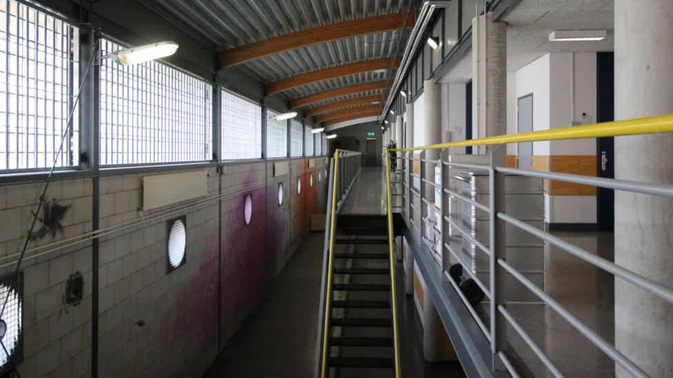 Many of the long prison corridors are quiet and empty when the inmates are in their rooms (Credit: Melissa Hogenboom) Many of the long prison corridors are quiet and empty when the inmates are in their rooms (Credit: Melissa Hogenboom)
