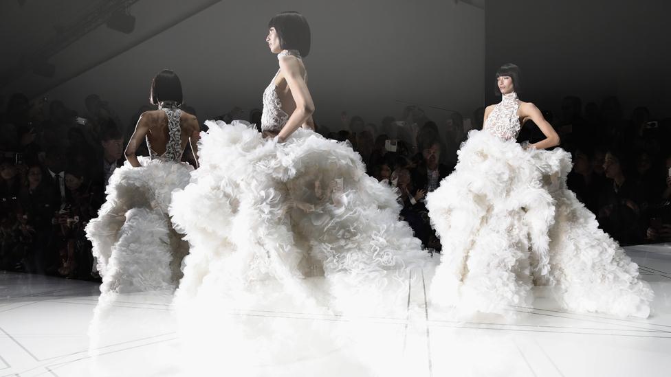 Design duo Ralph & Russo create bridal wear that is classic with a twist, much like Meghan's own personal style (Credit: Getty Images) Design duo Ralph & Russo create bridal wear that is classic with a twist, much like Meghan's own personal style (Credit: Getty Images)