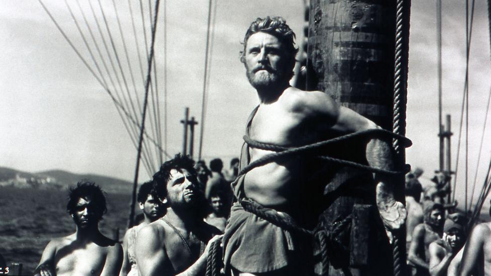 Kirk Douglas played Ulysses in the 1954 film based on Homer’s epic – in this scene, he listens to the song of the Sirens while strapped to a ship’s mast (Credit: Alamy) Kirk Douglas played Ulysses in the 1954 film based on Homer’s epic – in this scene, he listens to the song of the Sirens while strapped to a ship’s mast (Credit: Alamy)
