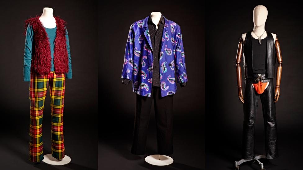Furry red gilet and tartan trousers, 1978; purple paisley jacket and Cartier shirt, 1985; leather chaps and waistcoat, 1992 (Credit: Brighton Museum & Gallery) Furry red gilet and tartan trousers, 1978; purple paisley jacket and Cartier shirt, 1985; leather chaps and waistcoat, 1992 (Credit: Brighton Museum & Gallery)