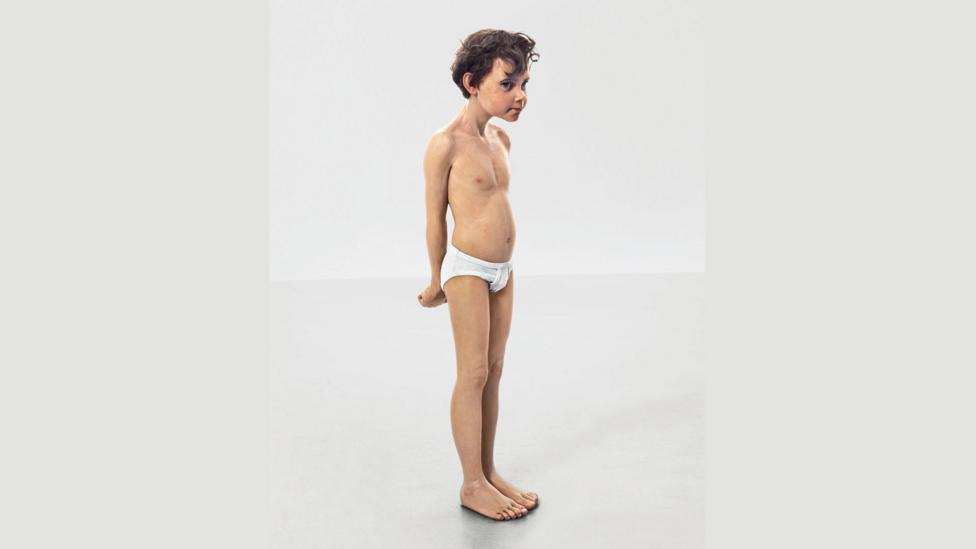 Mueck posed as Geppetto for Rego, holding his 1996 sculpture, Pinocchio, shown here (Credit: Ron Mueck, courtesy the artist/collection of Amy and John Phelan and Anthony d’Offay) Mueck posed as Geppetto for Rego, holding his 1996 sculpture, Pinocchio, shown here (Credit: Ron Mueck, courtesy the artist/collection of Amy and John Phelan and Anthony d’Offay)