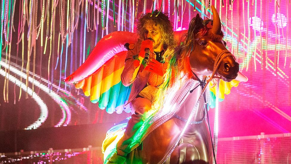 Wayne Coyne of The Flaming Lips riding a fake unicorn on stage is just one example of the recent resurgence of unicorns in popular culture (Credit: Getty) Wayne Coyne of The Flaming Lips riding a fake unicorn on stage is just one example of the recent resurgence of unicorns in popular culture (Credit: Getty)