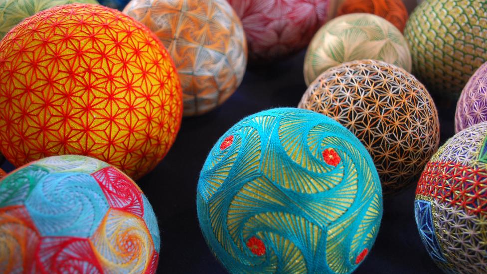 Brightly coloured thread balls in blue, red and oranges Brightly coloured thread balls in blue, red and oranges
