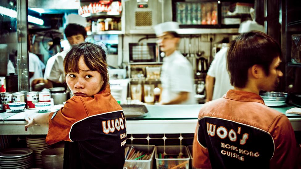 Waiters at a kitchen window at a busy restaurant in China (Credit: Getty Images) Waiters at a kitchen window at a busy restaurant in China (Credit: Getty Images)