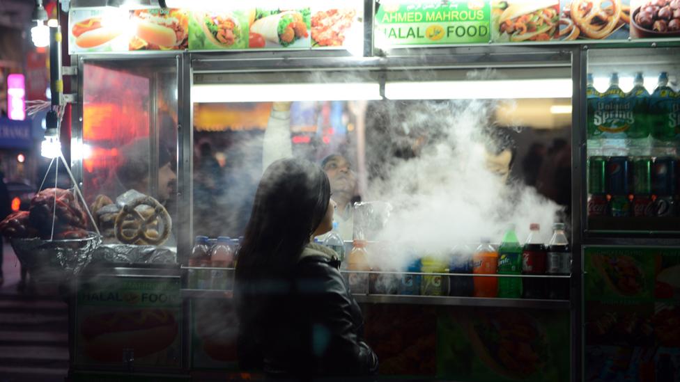 A woman waiting for food being prepared at a street stall (Credit: Getty Images) A woman waiting for food being prepared at a street stall (Credit: Getty Images)