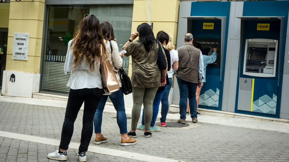 A queue of people waiting to use an ATM (Credit: Alamy) A queue of people waiting to use an ATM (Credit: Alamy)