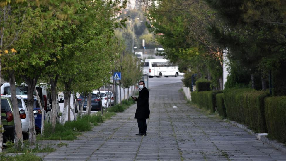 A man wearing a face mask stands in a deserted street in Turkey (Credit: Getty Images). A man wearing a face mask stands in a deserted street in Turkey (Credit: Getty Images).
