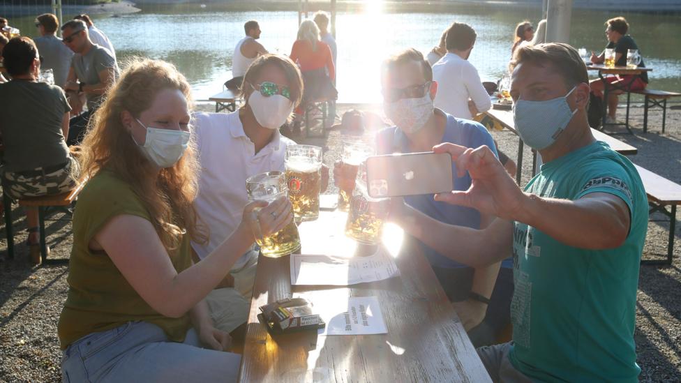 People gather on the first day that beer gardens were allowed to reopen in Munich (Credit: Getty Images)